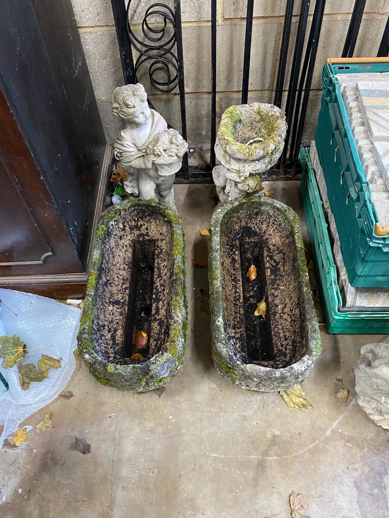 A small pair of rounded rectangular garden planters, a bird bath and two garden figures